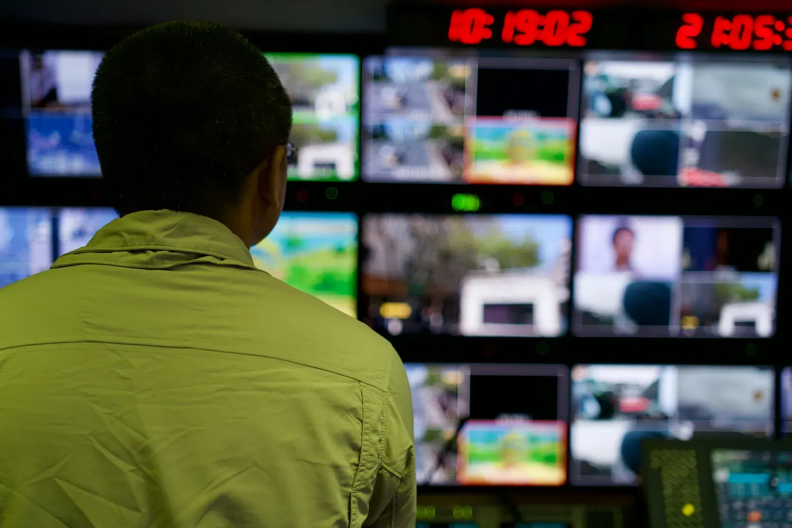 UAS operator monitoring drone telemetry on multiple control room screens