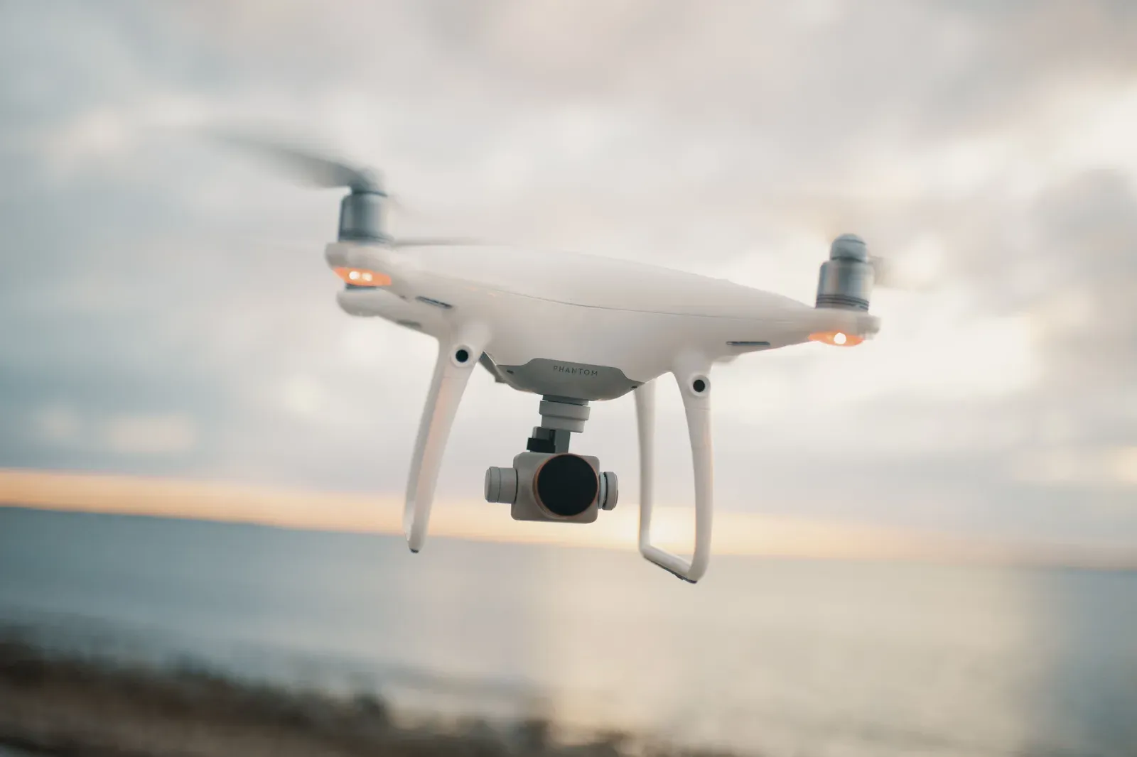 Commercial agricultural drone operating over a US farm field at sunset