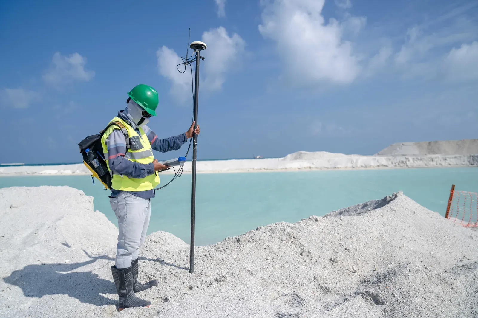Surveyor piloting a mapping drone over a construction site