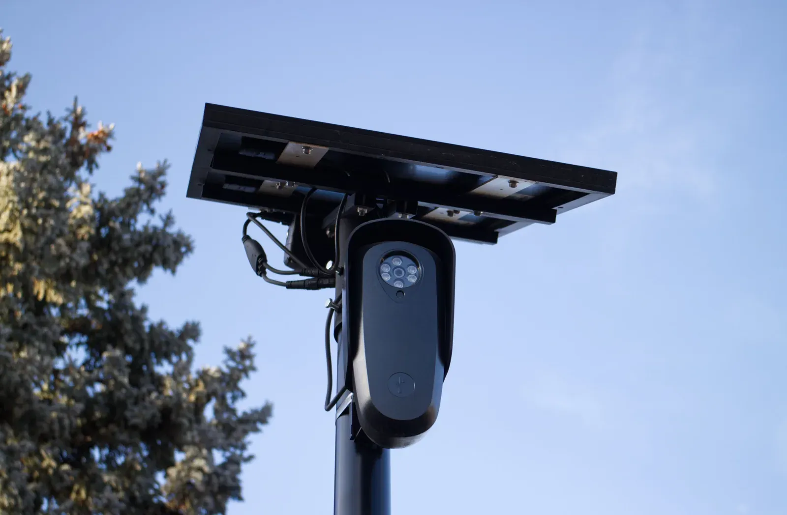 Pan-tilt-zoom electro-optical surveillance camera mounted on a mast