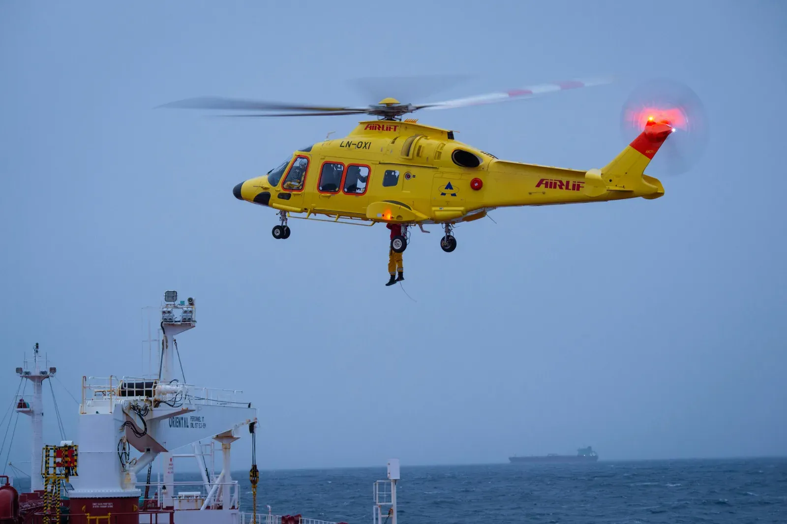 An offshore wind turbine platform being serviced by an aerial vehicle over open water