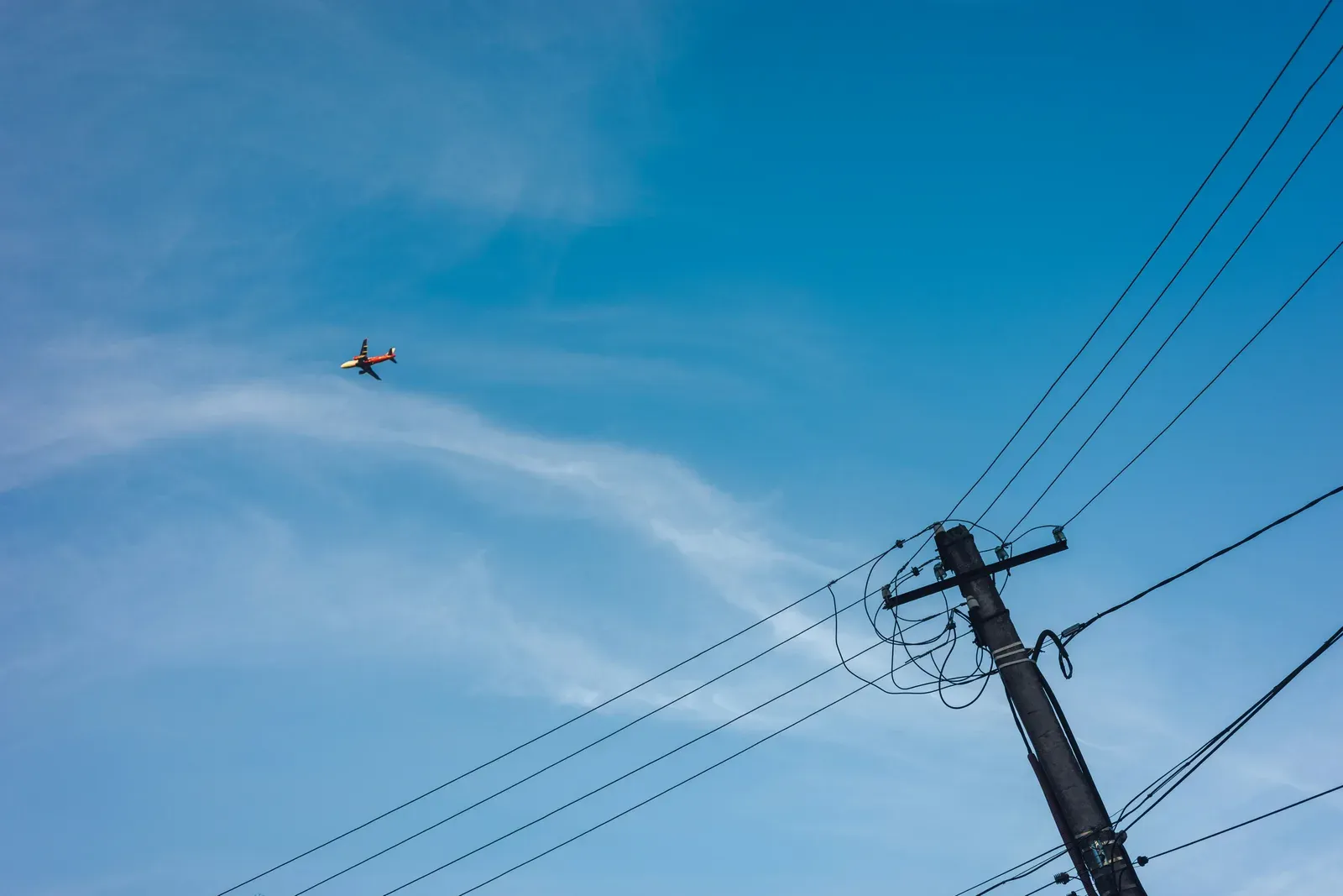 Inspection drone flying close to high-voltage transmission lines