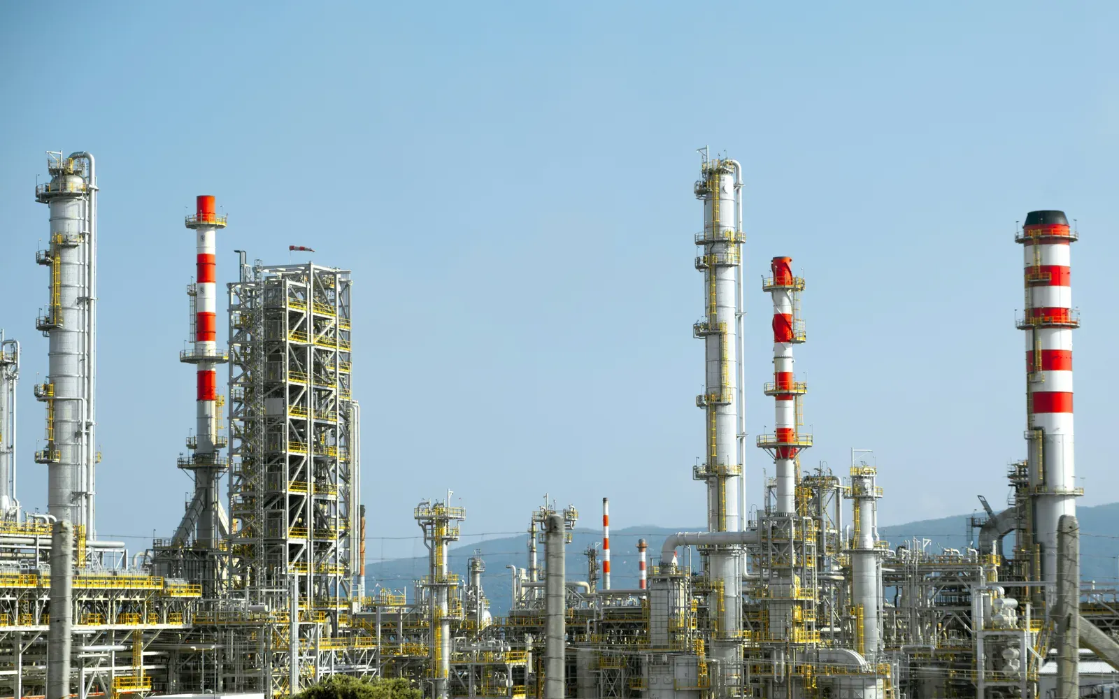 Industrial inspection drone flying near refinery infrastructure