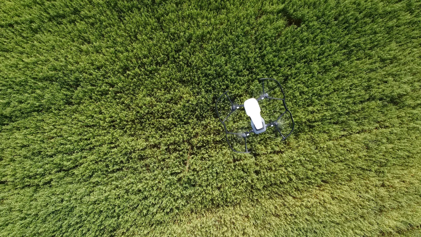 Drone pilot reviewing a compliance checklist beside a UAV in the field