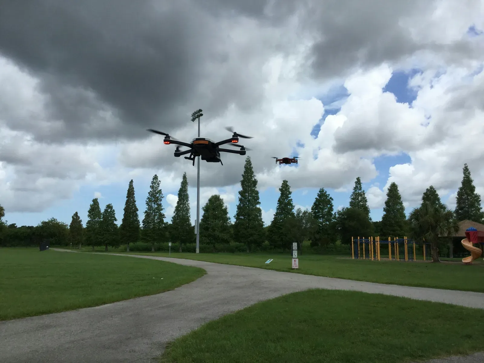 Quadcopter delivery drone carrying a small package in flight