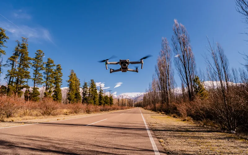 Commercial delivery drone flying above an open landscape representing BVLOS operations
