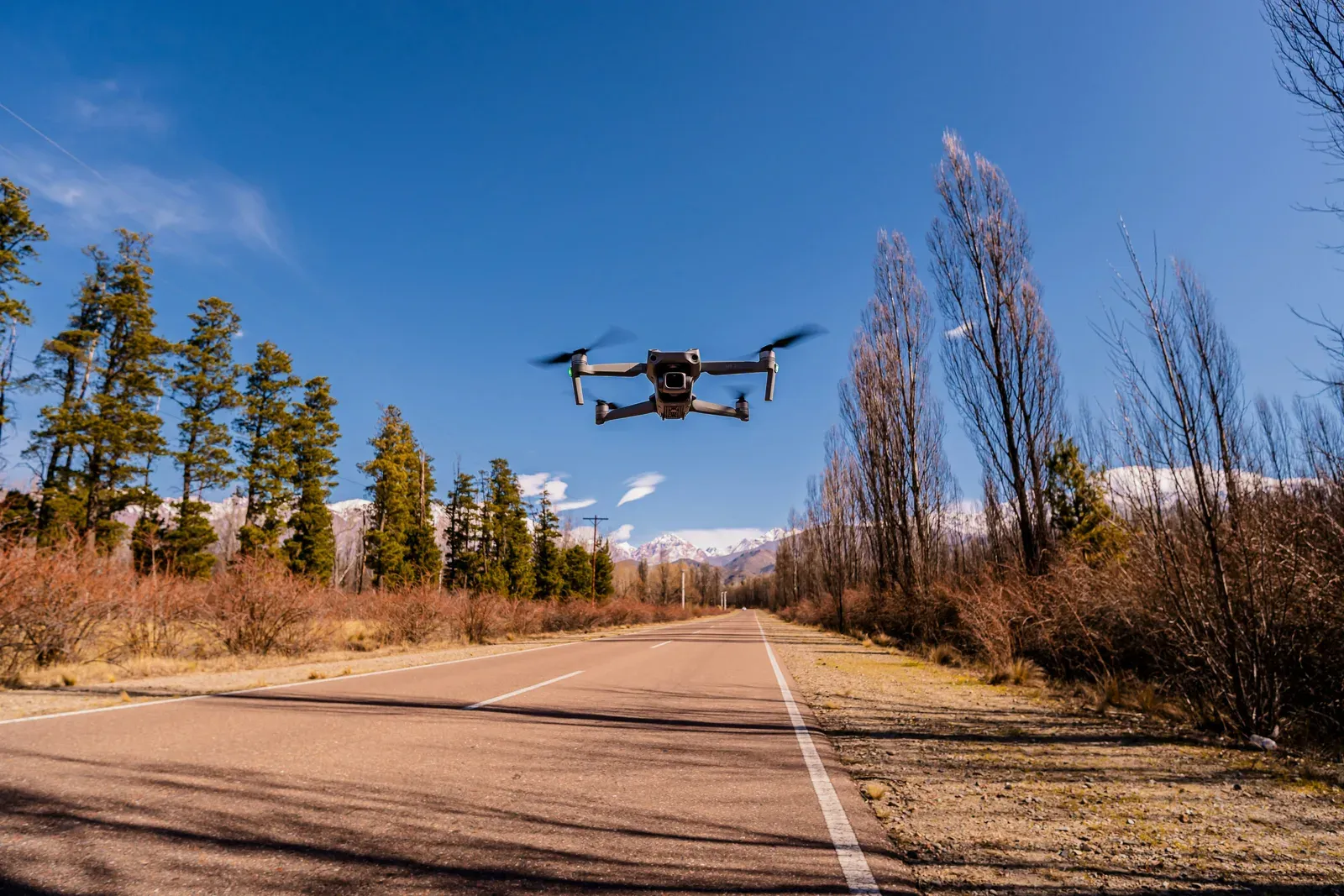 Commercial delivery drone flying above an open landscape representing BVLOS operations