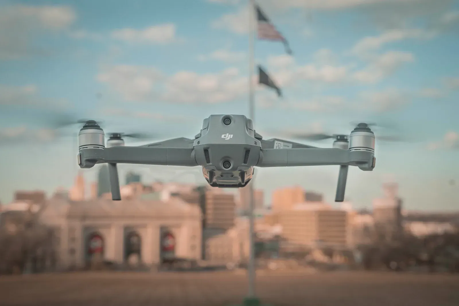 Commercial drone flying with an American flag in the background