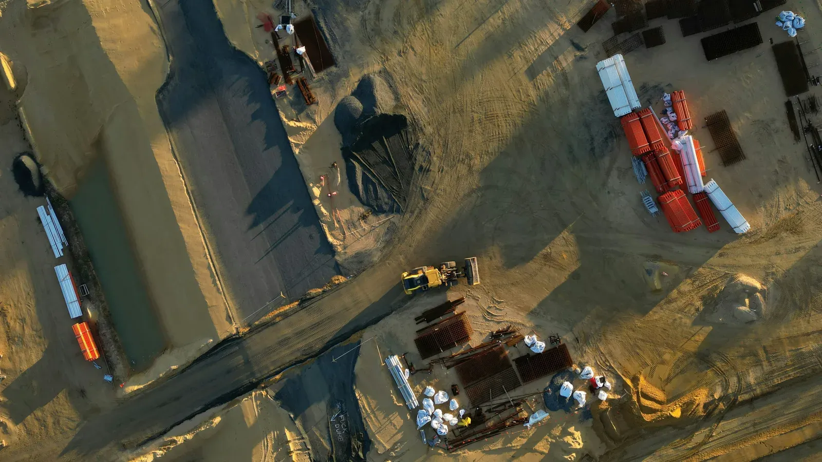 Surveyor operating a mapping drone over a construction site