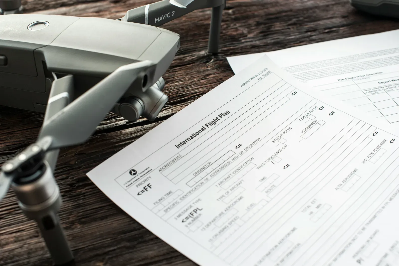 Federal aviation regulation documents next to a small unmanned aircraft