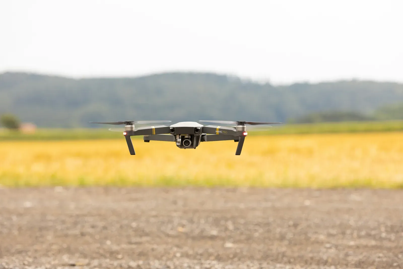 Remote pilot operating a drone with a tablet showing airspace data