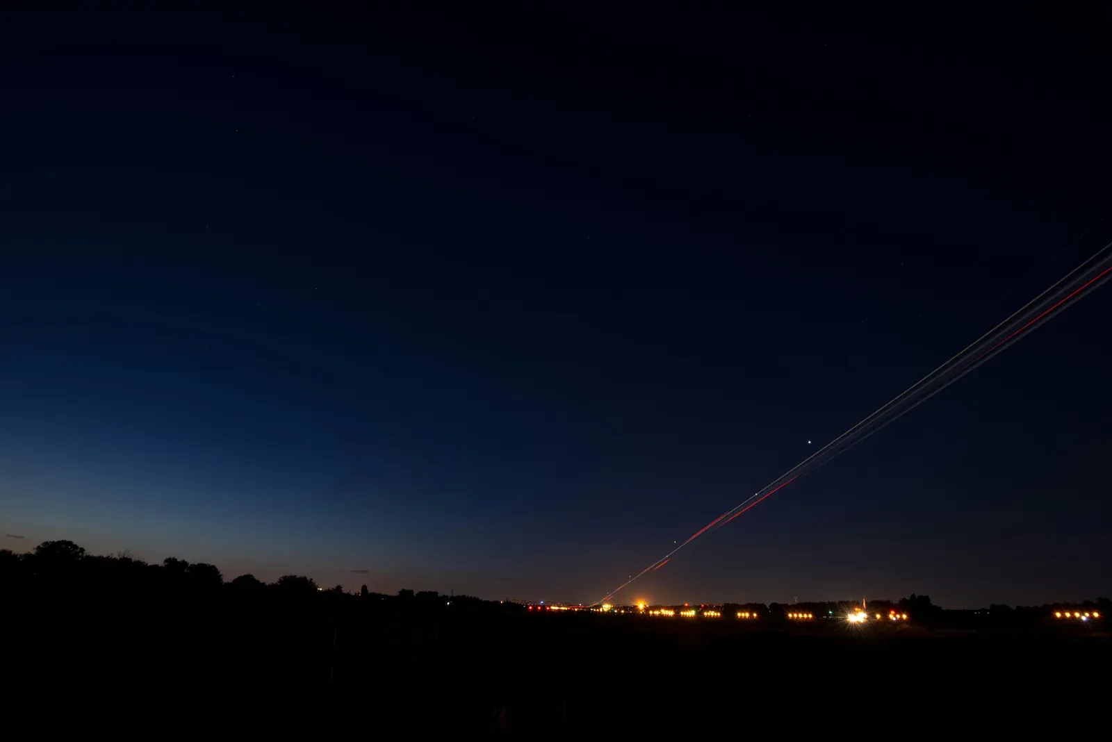 Anti-aircraft tracer fire streaking into a night sky